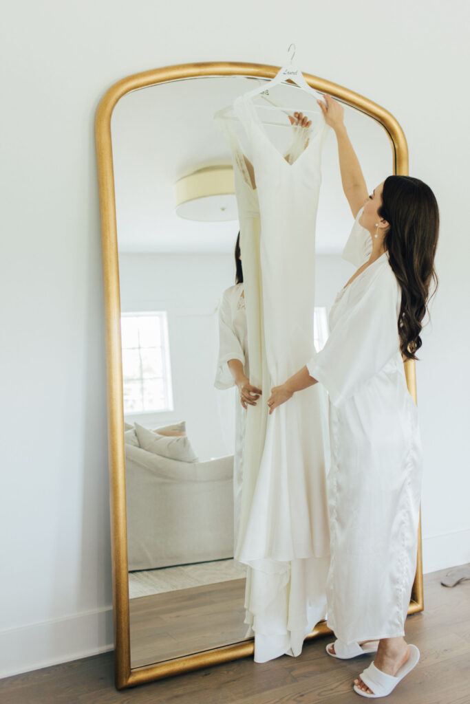 Bride puts on her dress in the luxurious getting ready suites at The Hutton House