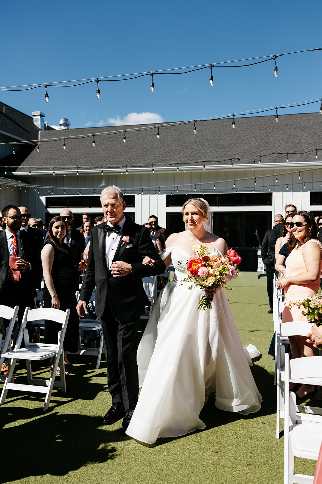 Bride walking down the aisle at gorgeous outdoor courtyard wedding ceremony at The Hutton House